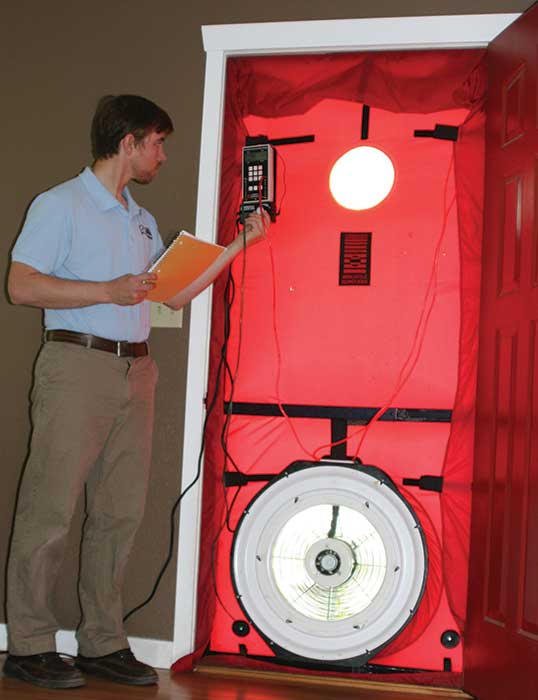 Blower door test being performed